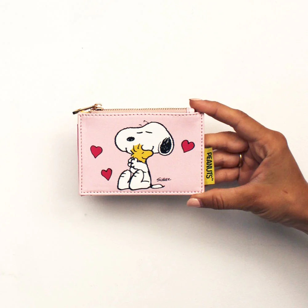 Hand holding the Peanuts Love zip purse