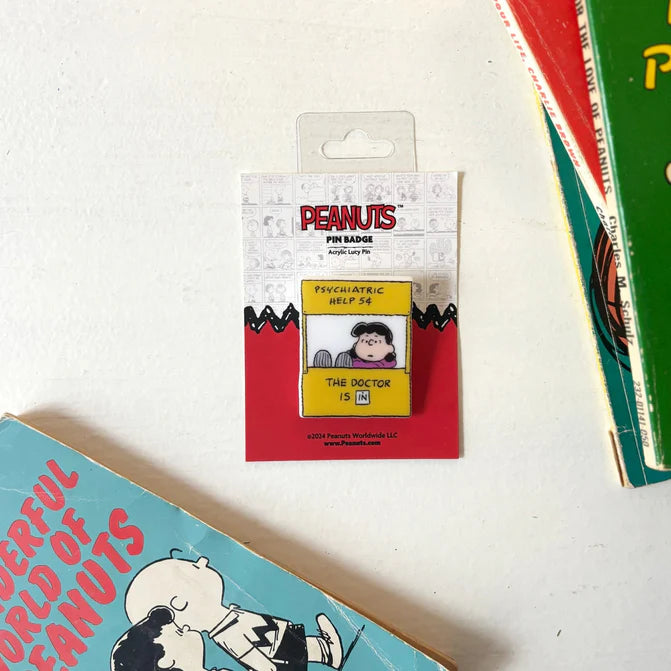 Peanuts Lucy 'Psychiatric help 5¢' acrylic pin on its card