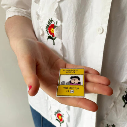 Hand holding the Lucy pin