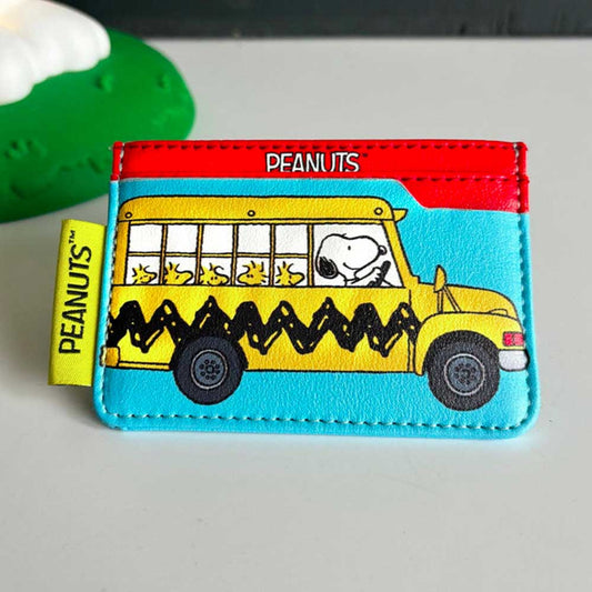 Peanuts card holder in turquoise faux leather with a red top, printed with Snoopy driving a yellow school bus full of Woodstocks