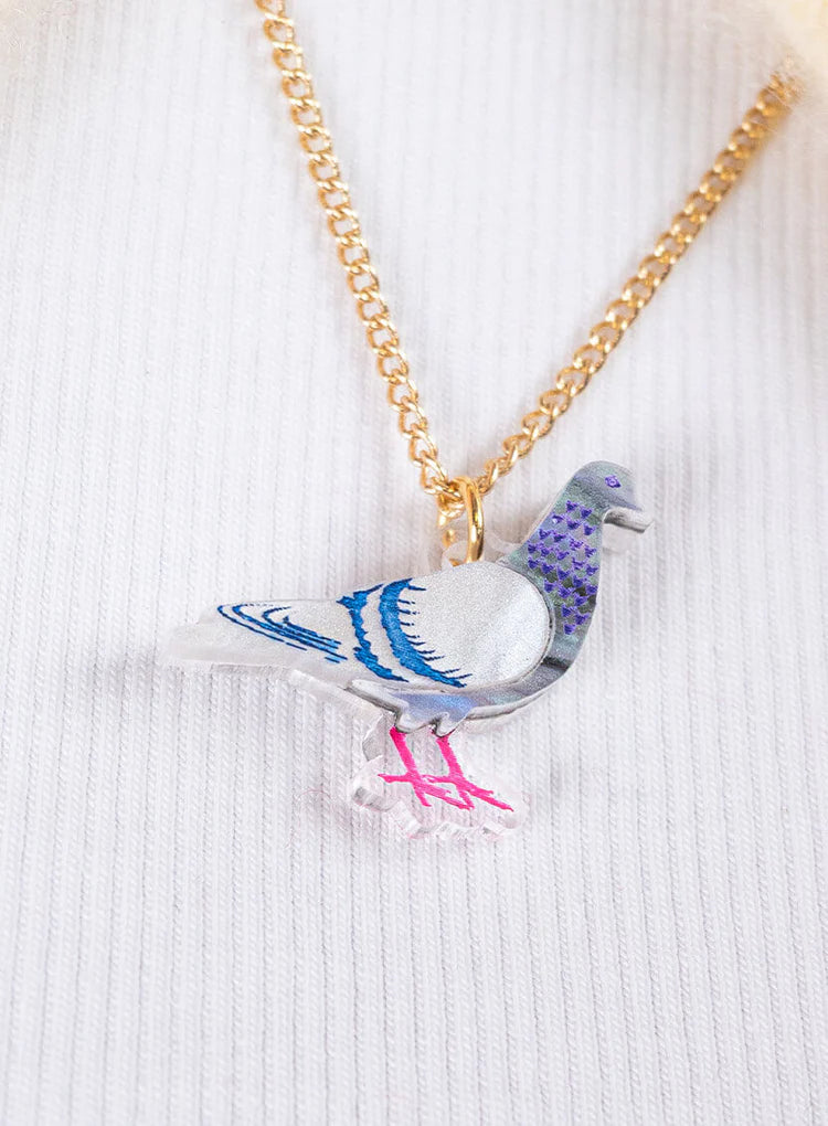 Pigeon pendant worn with a white jumper