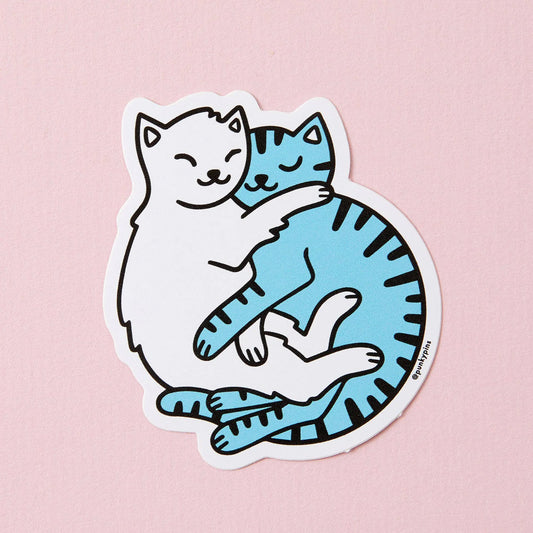 Sticker of a white cat and a blue tabby cat cuddling