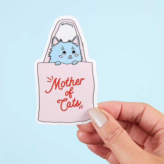 Hand holding a tote bag sticker with a blue cat: Mother of cats