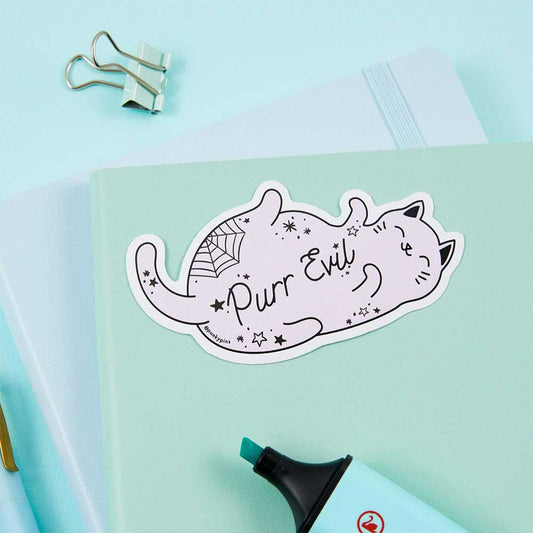 Lilac cat sticker with a spider web: Purr evil, on a mint notebook