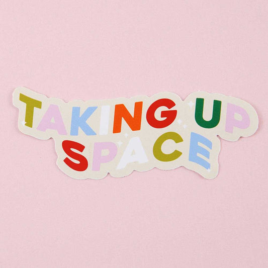 Punky Pins sticker in bright multicoloured letters reading 'Taking up space'