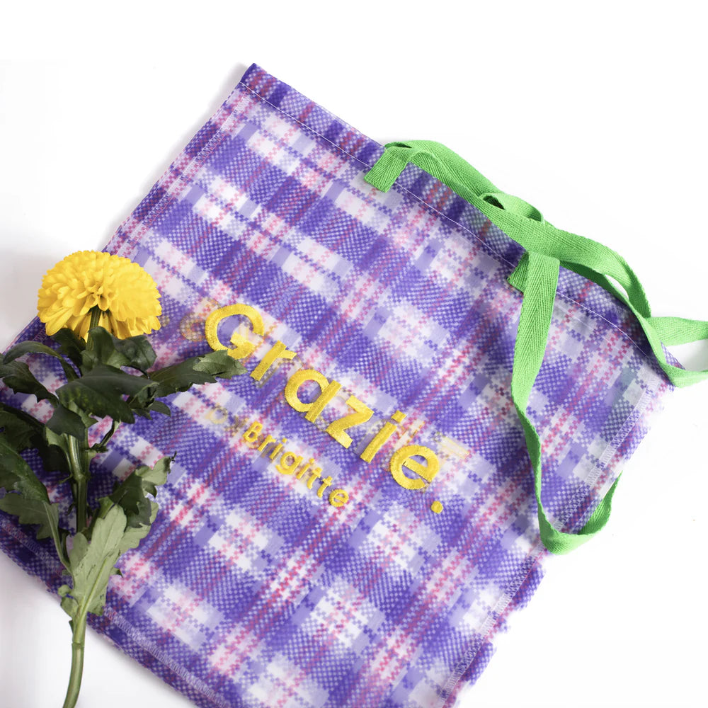 Grazie organza bag beside yellow flowers