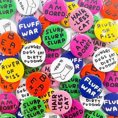 A pile of colourful David Shrigley badges