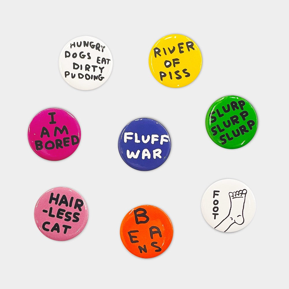 David Shrigley badge set: eight colourful badges reading things like 'I am bored', 'Fluff war', 'River of piss' and 'Hairless cat'