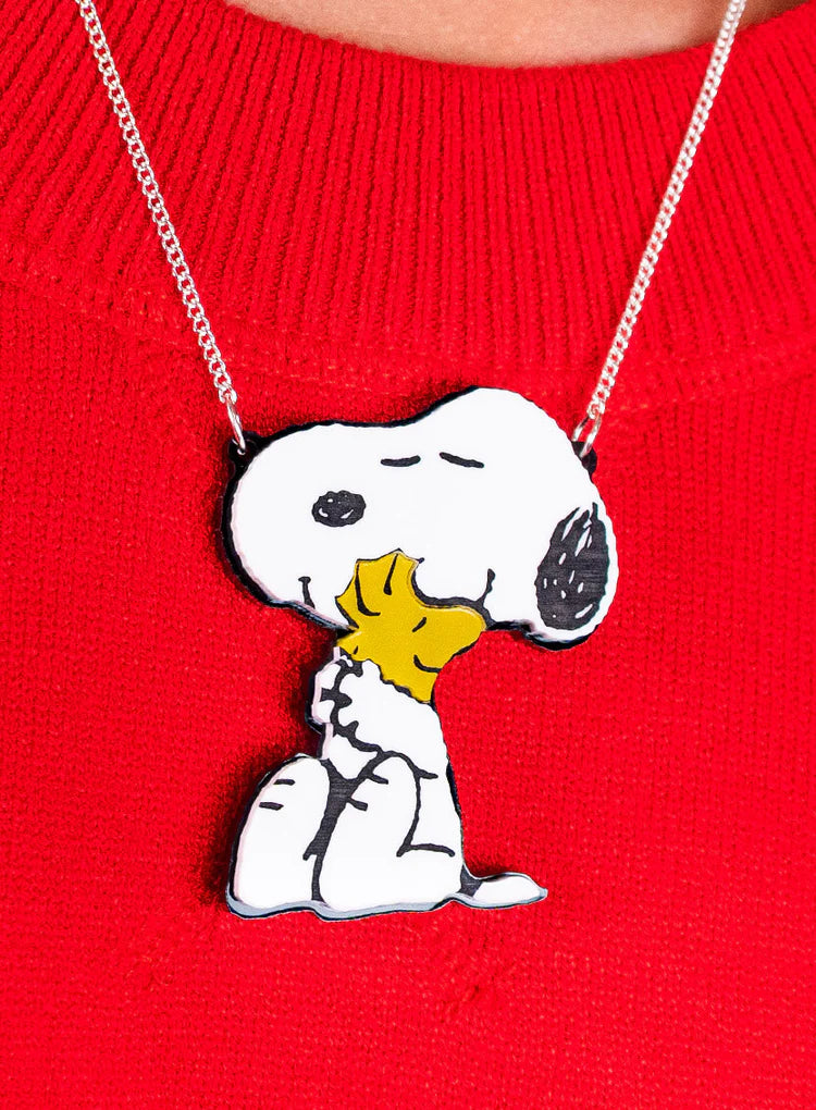 Snoopy and Woodstock necklace worn on a red jumper