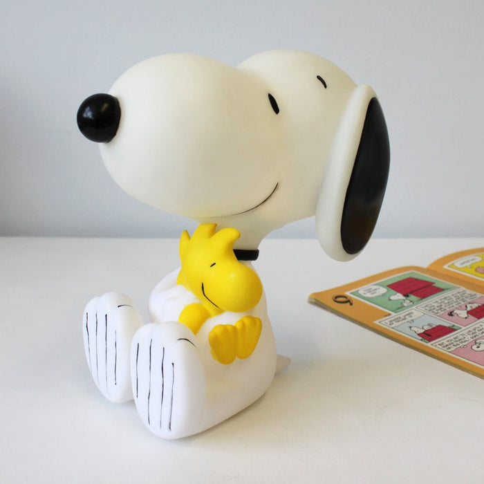 Snoopy lamp beside a Peanuts comic book