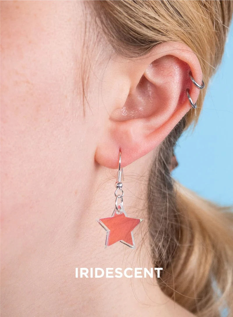 Iridescent star earring worn