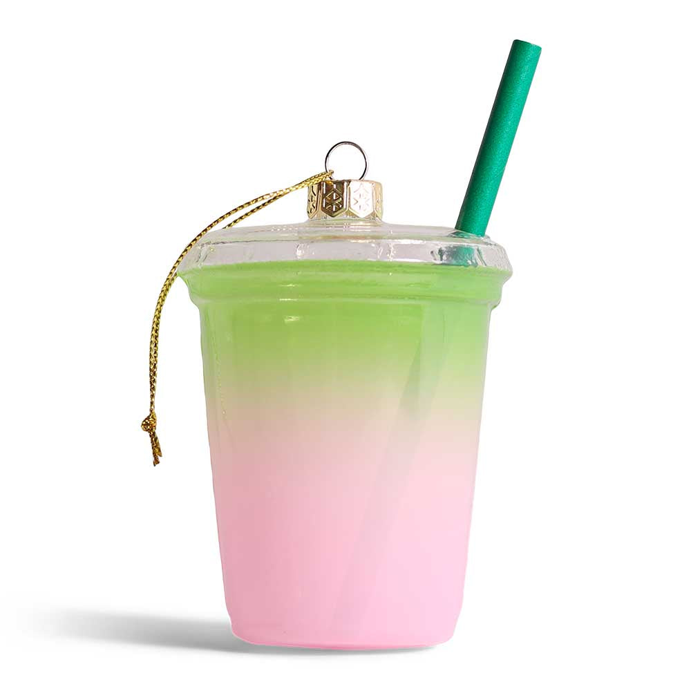 Glass decoration of a pink and green blueberry drink with a straw