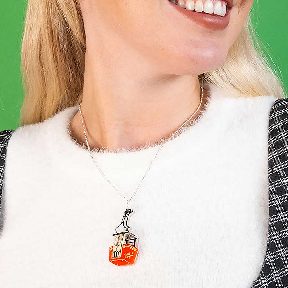 Smiling woman wearing the cable car pendant