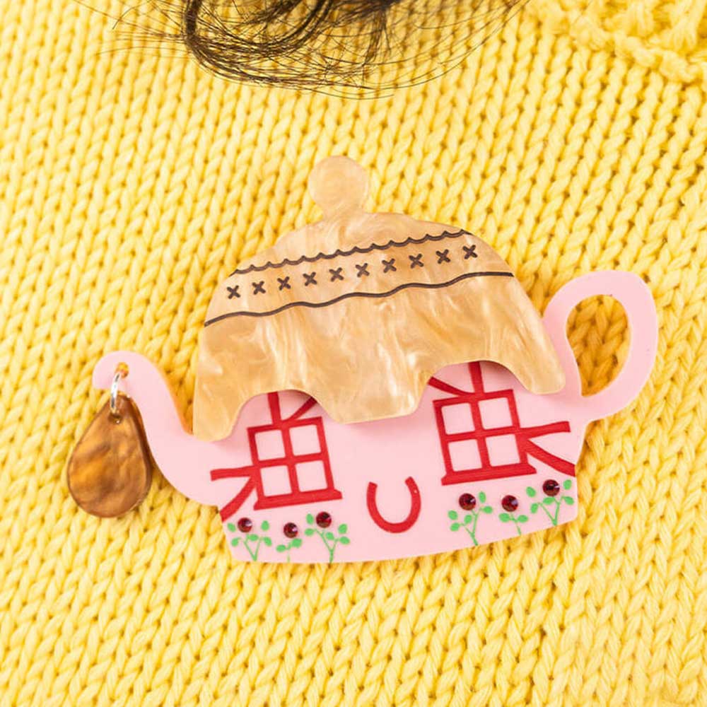 Cottage teapot brooch on a yellow knit