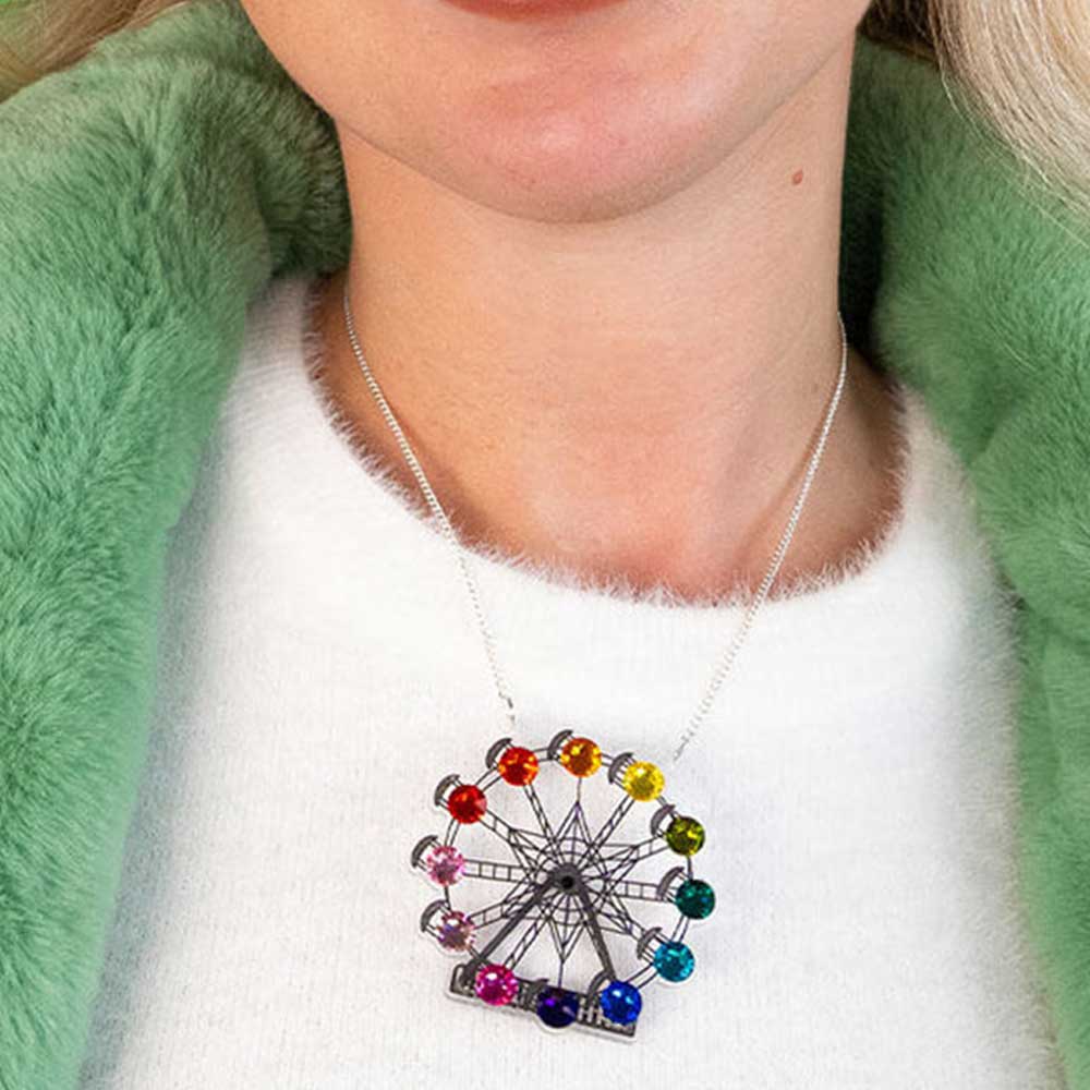 Ferris wheel necklace worn with a green coat