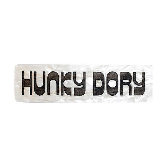 Tatty Devine pearly hair clip reading 'Hunky dory' in black