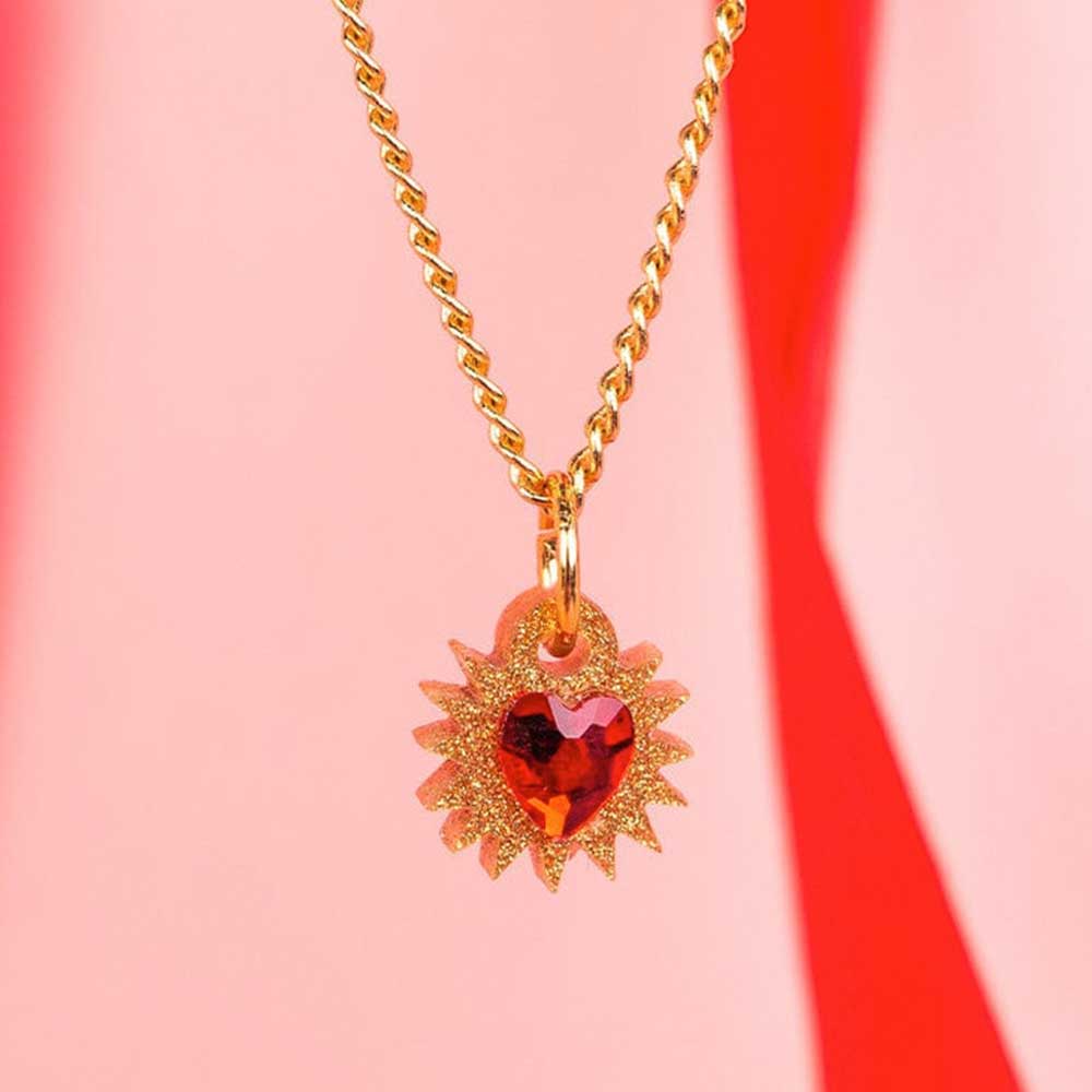 Mini immaculate heart pendant against pink