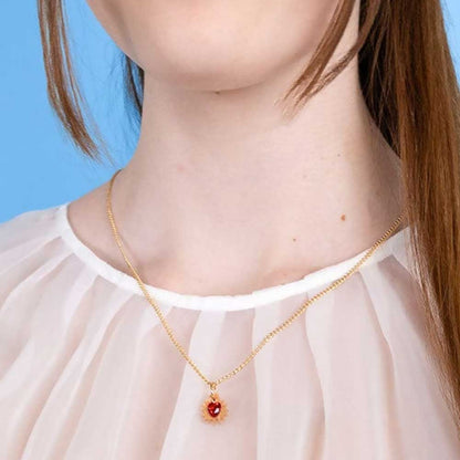Mini immaculate heart pendant worn with a sheer white blouse