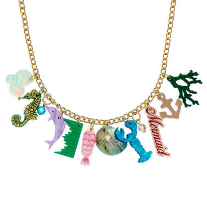 Tatty Devine seaside charm statement necklace: a seahorse, dolphin, lobster, mermaid script and coral on a gold chain