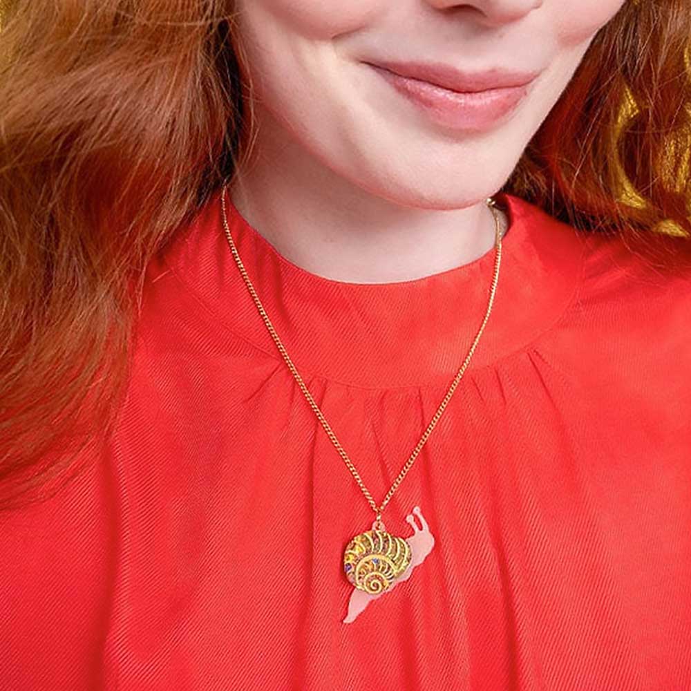 Woman wearing the snail pendant with a red top