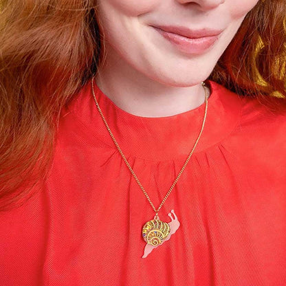 Woman wearing the snail pendant with a red top