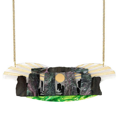 Acrylic Stonehenge necklace with a gold sun and green grass on a gold chain