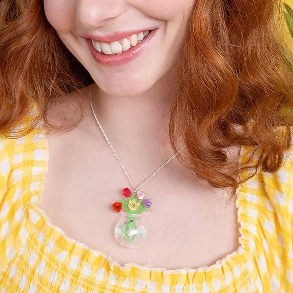 Smiling woman in a yellow gingham top wearing the tulip vase pendant