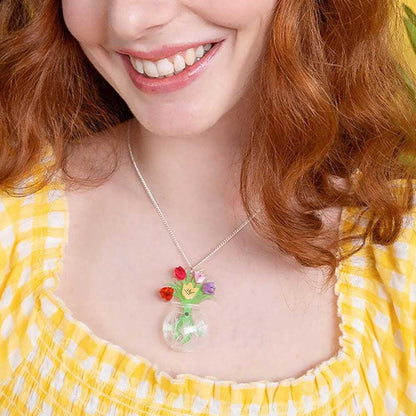 Smiling woman in a yellow gingham top wearing the tulip vase pendant