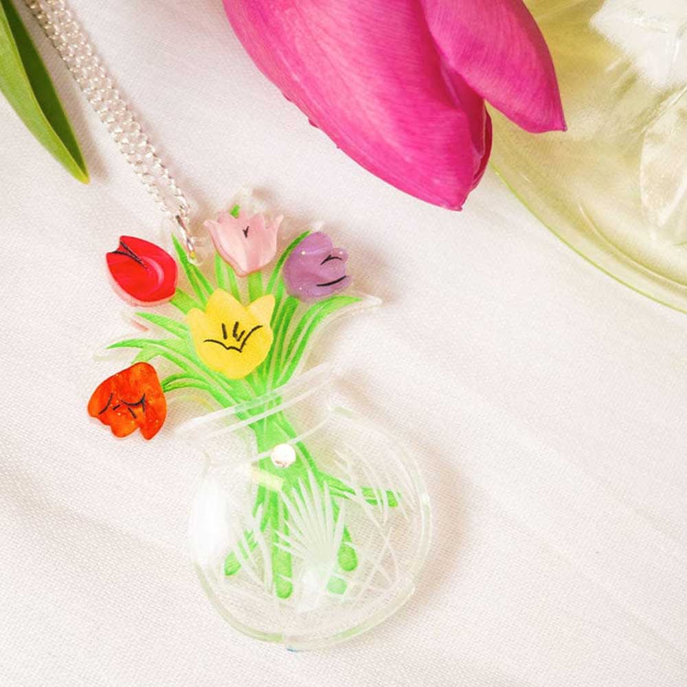 Tulip vase pendant beside real tulips
