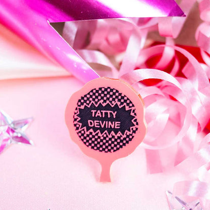 Whoopie cushion brooch among pink ribbons