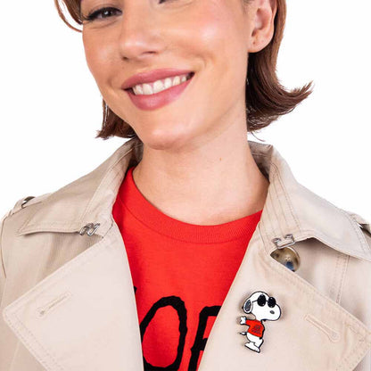 Smiling woman wearing the Joe Cool brooch on a trench coat
