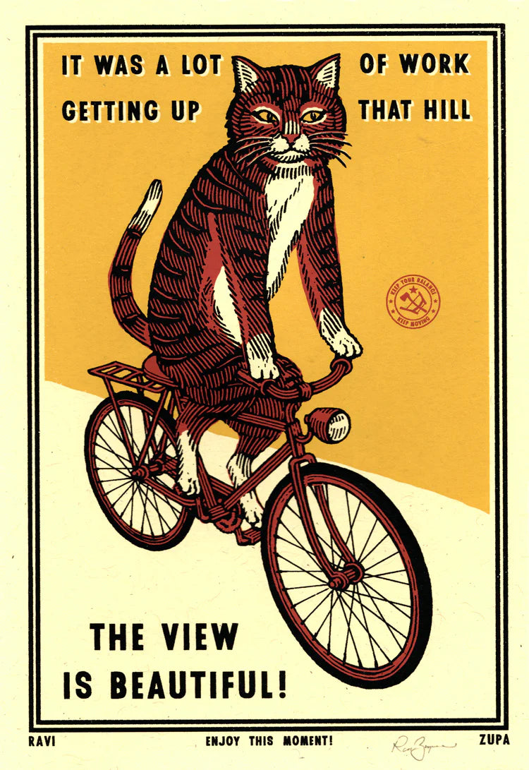 Ravi Zupa A5 print: a tabby cat on a bicycle, with 'It was a lot of work getting up that hill – The view is beautiful!'