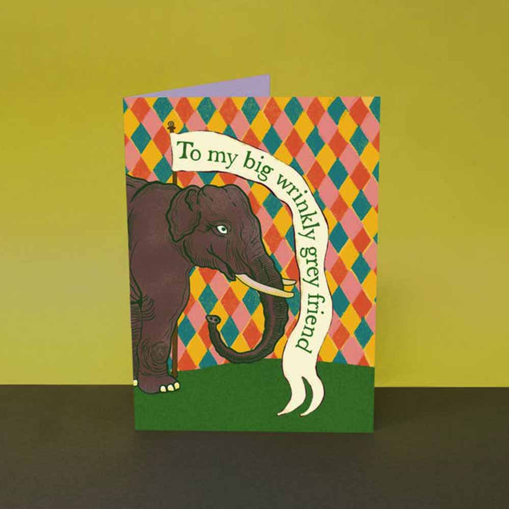 Card with an elephant on a harlequin pattern holding a banner: To my big wrinkly grey friend