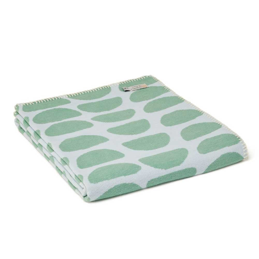 Tweedmill cotton throw with a green half-moon pattern on pale blue, folded