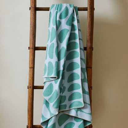 Half-moon throw hanging on a wooden ladder