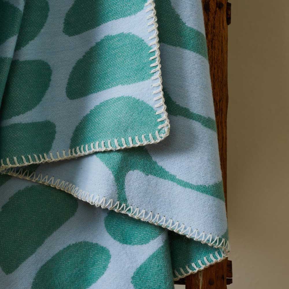 Close-up of the half-moon throw's blanket-stitch edge