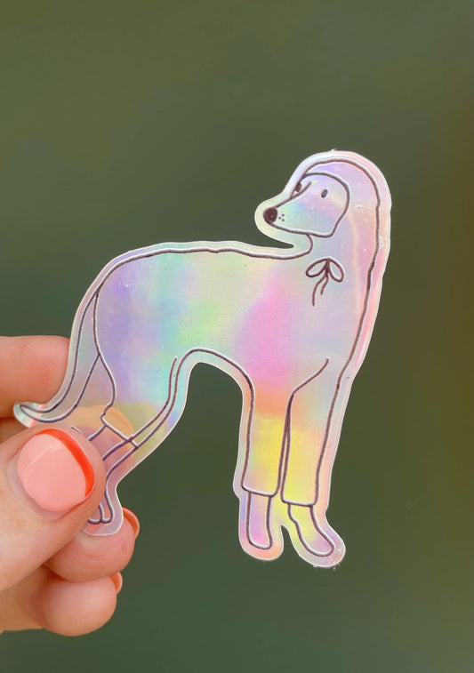Naomi Wilkinson holographic whippet sticker, held in a hand