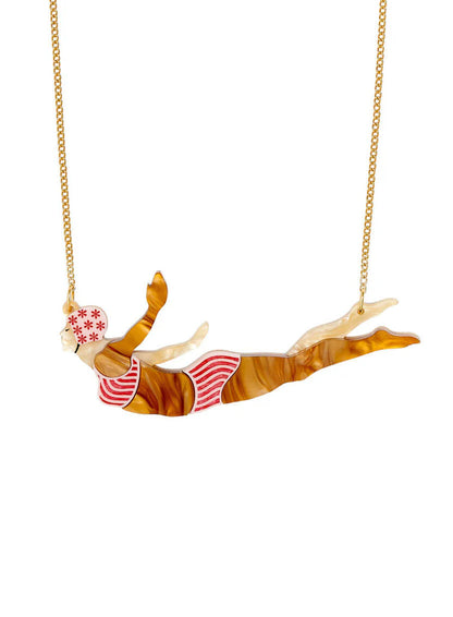Acrylic necklace of a diving woman in a pink and white swimsuit and floral swim cap on a gold chain