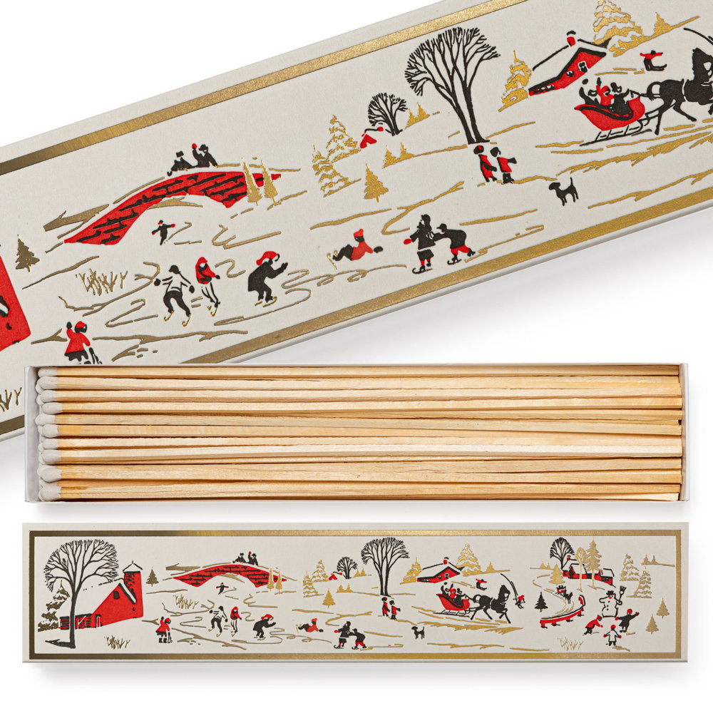 Long matchbox with a vintage winter snowscape of skaters and a sleigh, opened to show the long matches